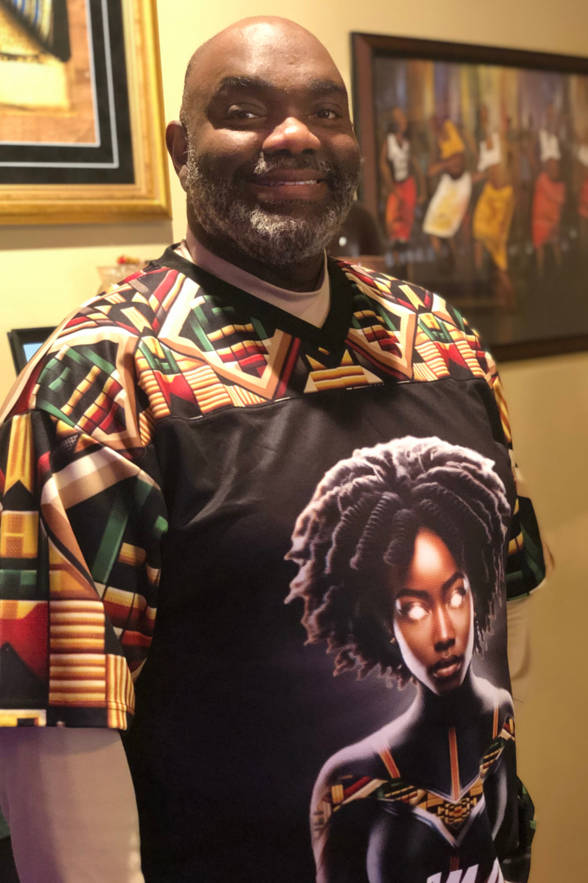 Black Male wearing a Dashiki with a Black Female Superhero wearing Kente Print
