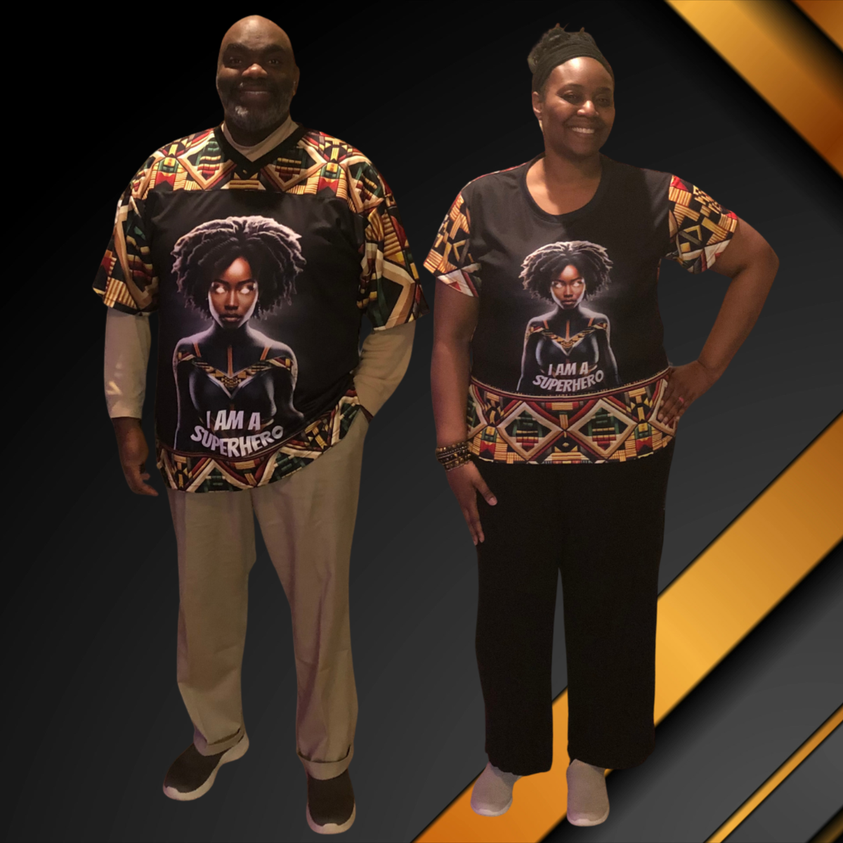 A man and woman wearing black shirts with colorful Kente-inspired patterns, Black superheroine artwork, and “I Am a Superhero” lettering.