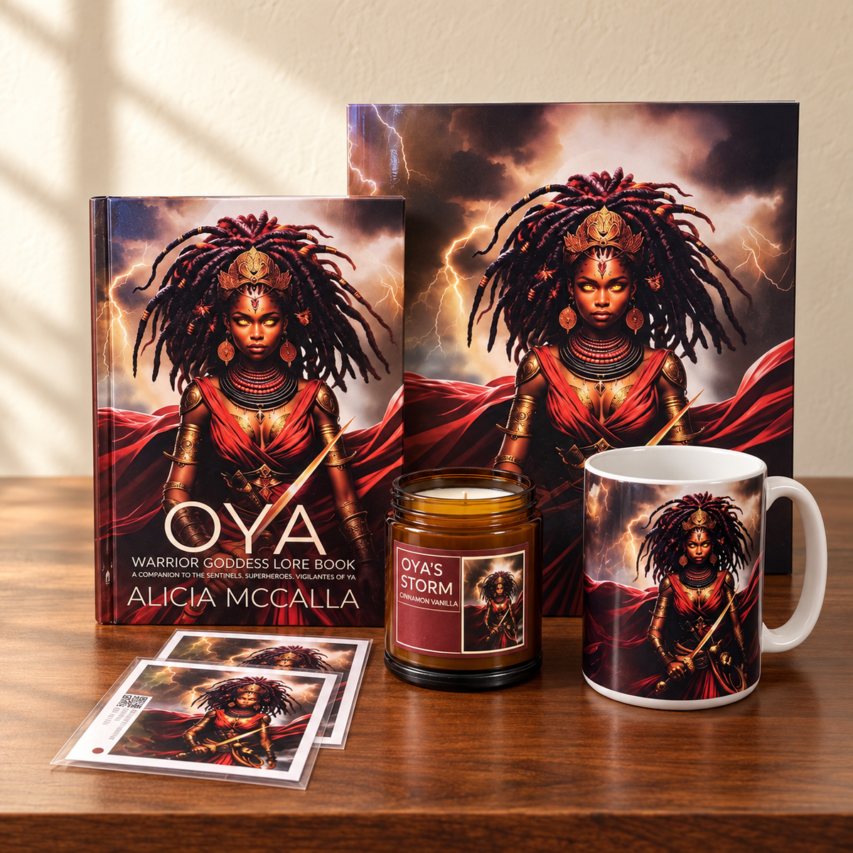 Oya Storm Goddess collection by Alicia McCalla featuring the Oya Warrior Goddess Lore Book, art print, candle, mug, and illustrated cards on a wooden tabletop.